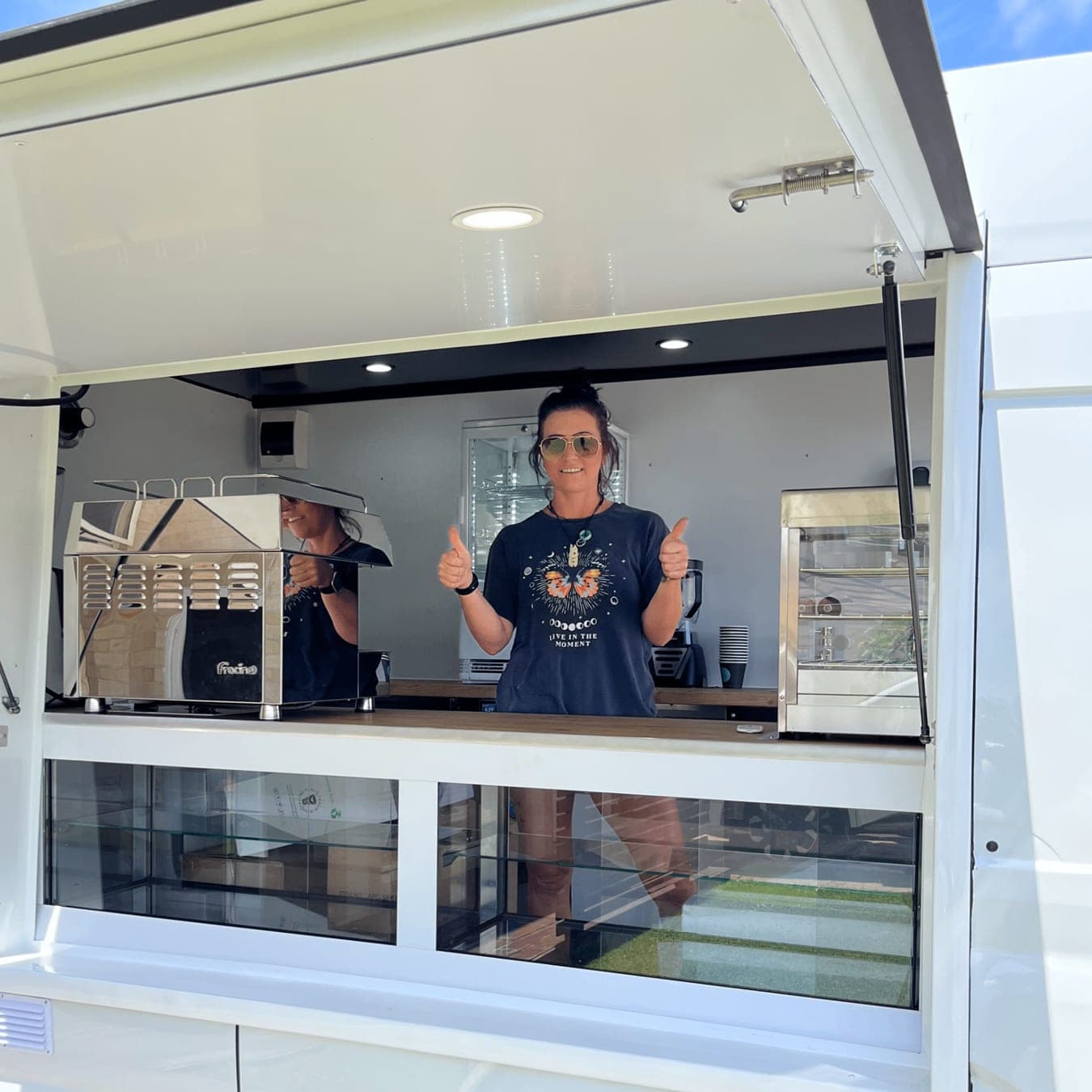 A walk-in coffee van trading at an event