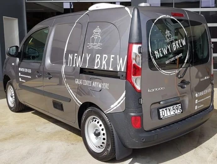 Branded compact coffee van outside the workshop