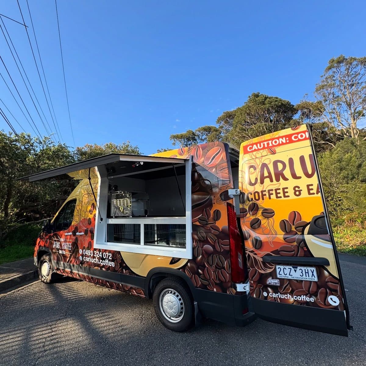 Reference photograph of a walk-in coffee van with its service hatch open